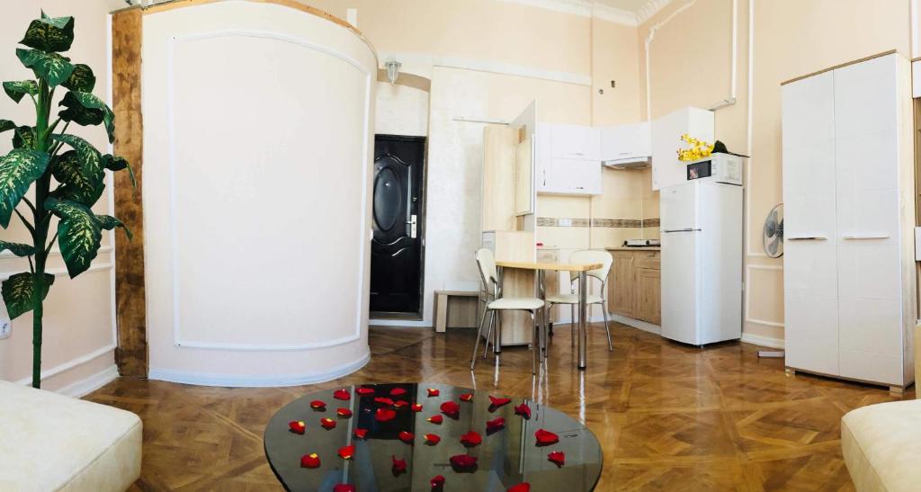 a living room with a table with roses on it at Apartment in the city center in Ivano-Frankivsʼk