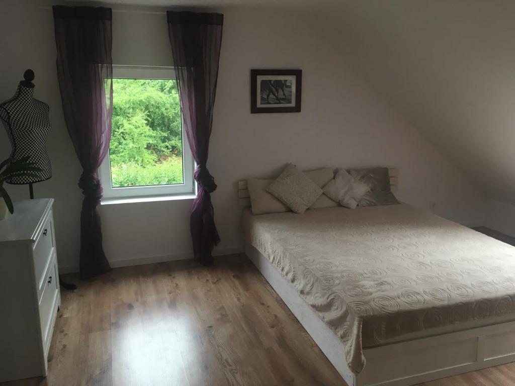 a bedroom with a bed and a window at Apartament Lipowa in Mosty