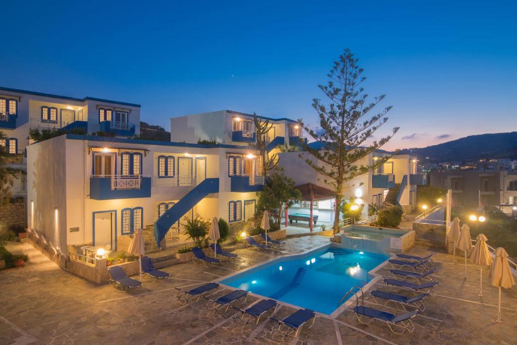 a villa with a swimming pool at night at Belvedere Village in Agia Pelagia