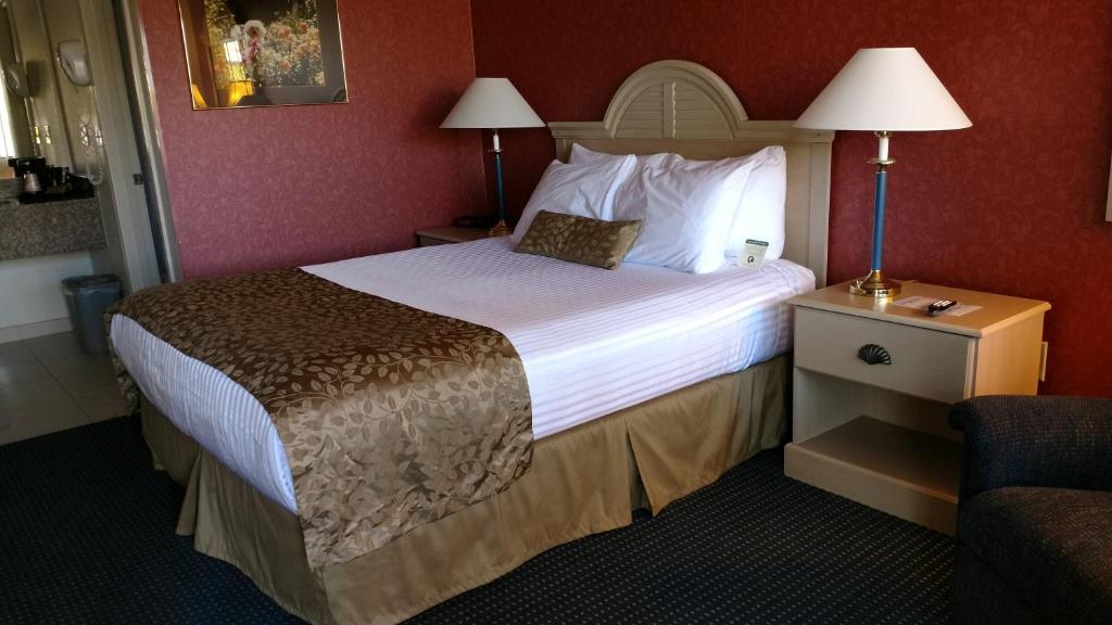 a hotel room with a large bed and a chair at Lewis River Inn in Woodland