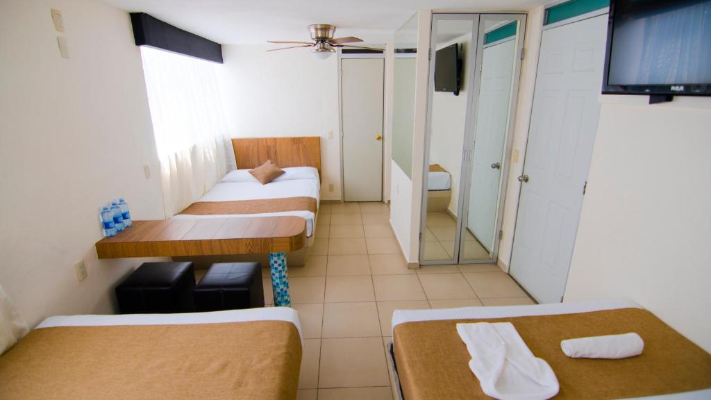 Postel nebo postele na pokoji v ubytování Hotel Tepic