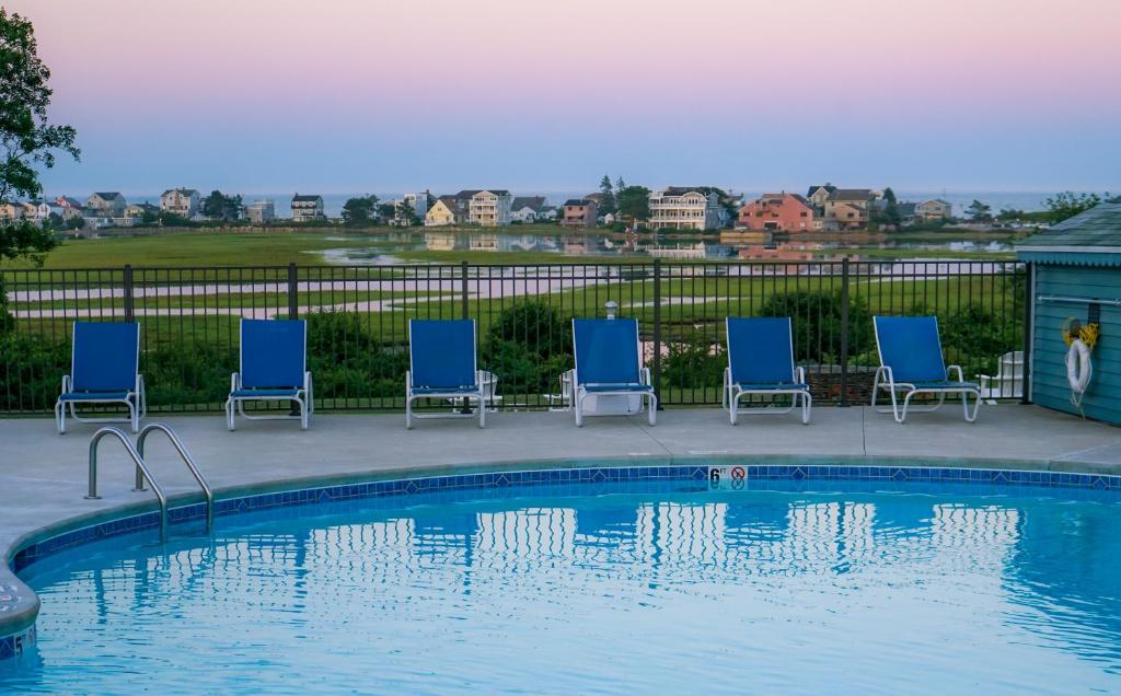 a group of chairs sitting around a swimming pool at Mariner Resort in Ogunquit