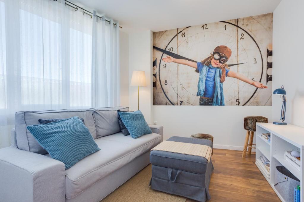 a living room with a couch and a clock at Mariacka1 in Szczecin