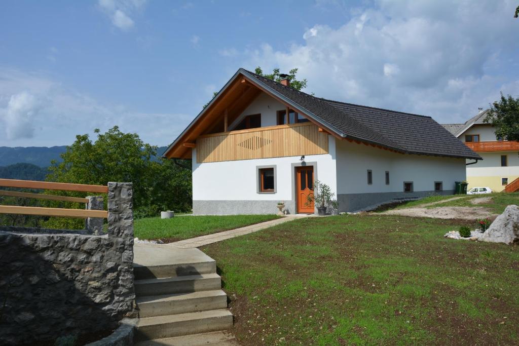 Biały dom z brązowym dachem w obiekcie Grandma's House w Bledzie