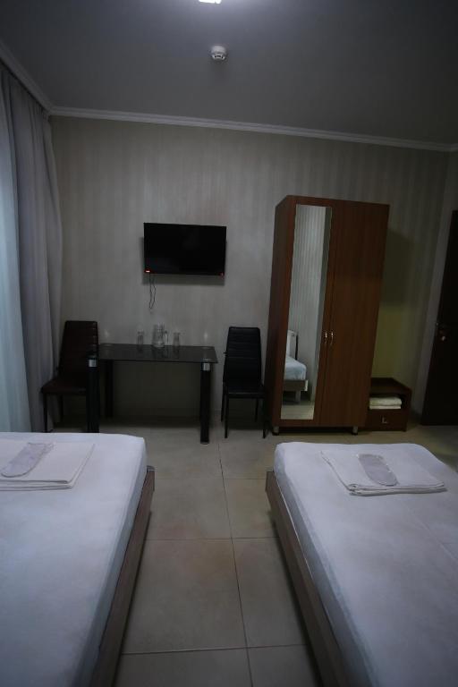 Postel nebo postele na pokoji v ubytování Hotel Okriba Tbilisi