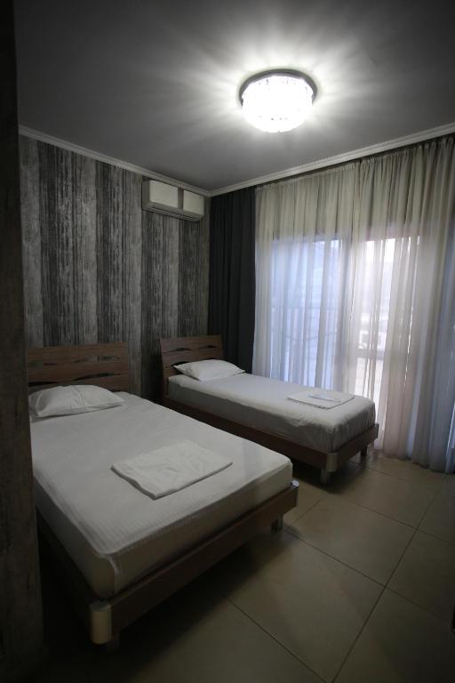 Postel nebo postele na pokoji v ubytování Hotel Okriba Tbilisi