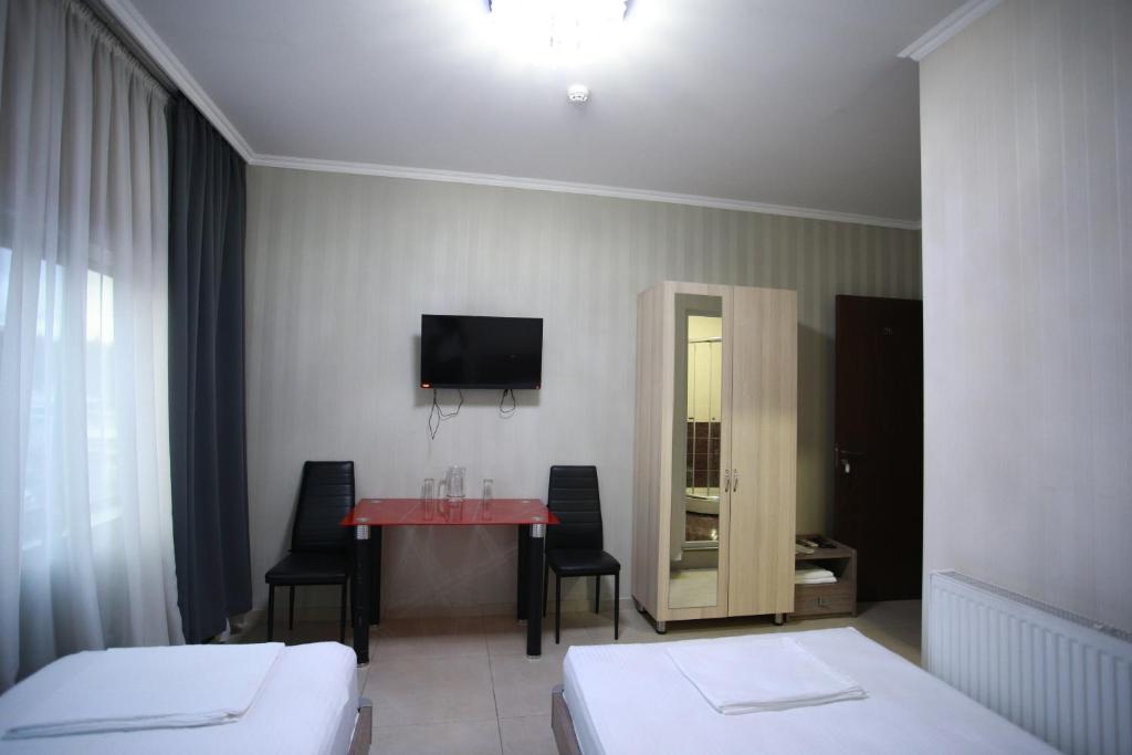 Postel nebo postele na pokoji v ubytování Hotel Okriba Tbilisi