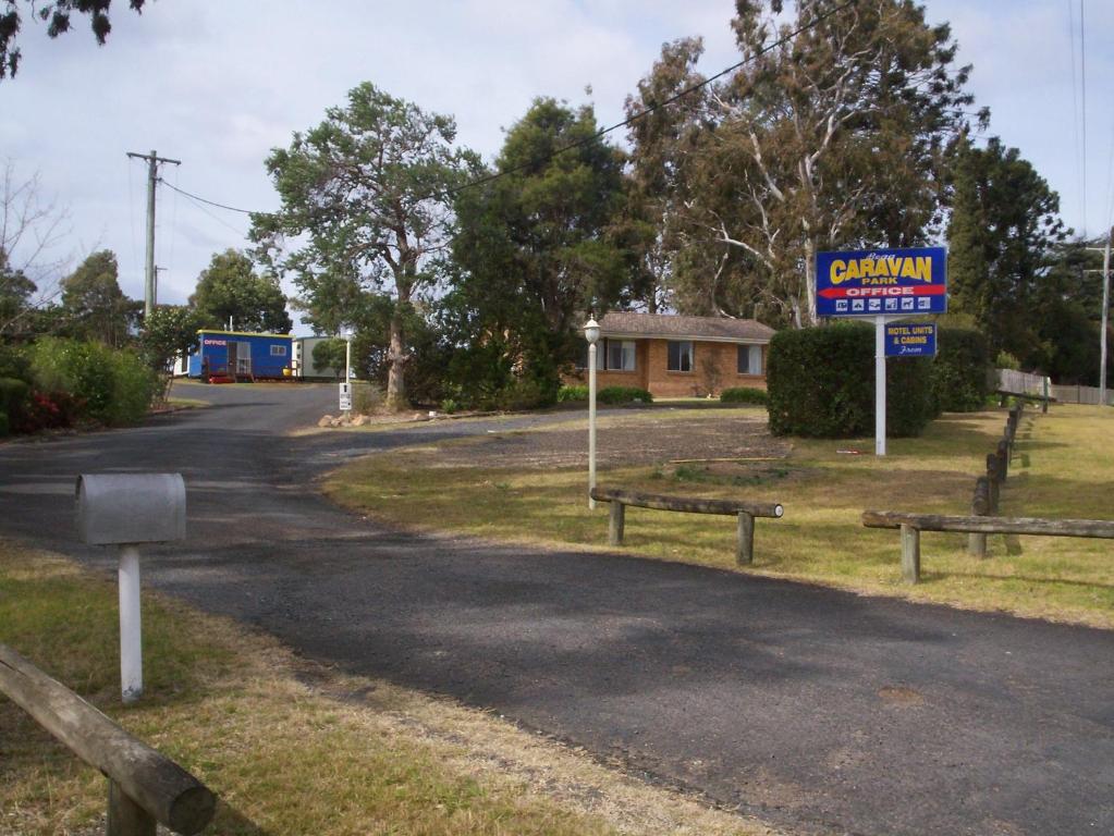 a sign for a gas station on the side of a road at Bega Caravan Park in Bega