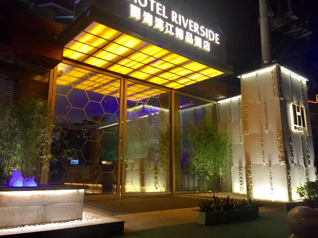 a building with a sign that reads united riverside hotel at H-hotel Riverside in Chengdu