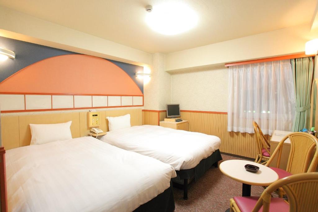 Postel nebo postele na pokoji v ubytování Hotel Marutani