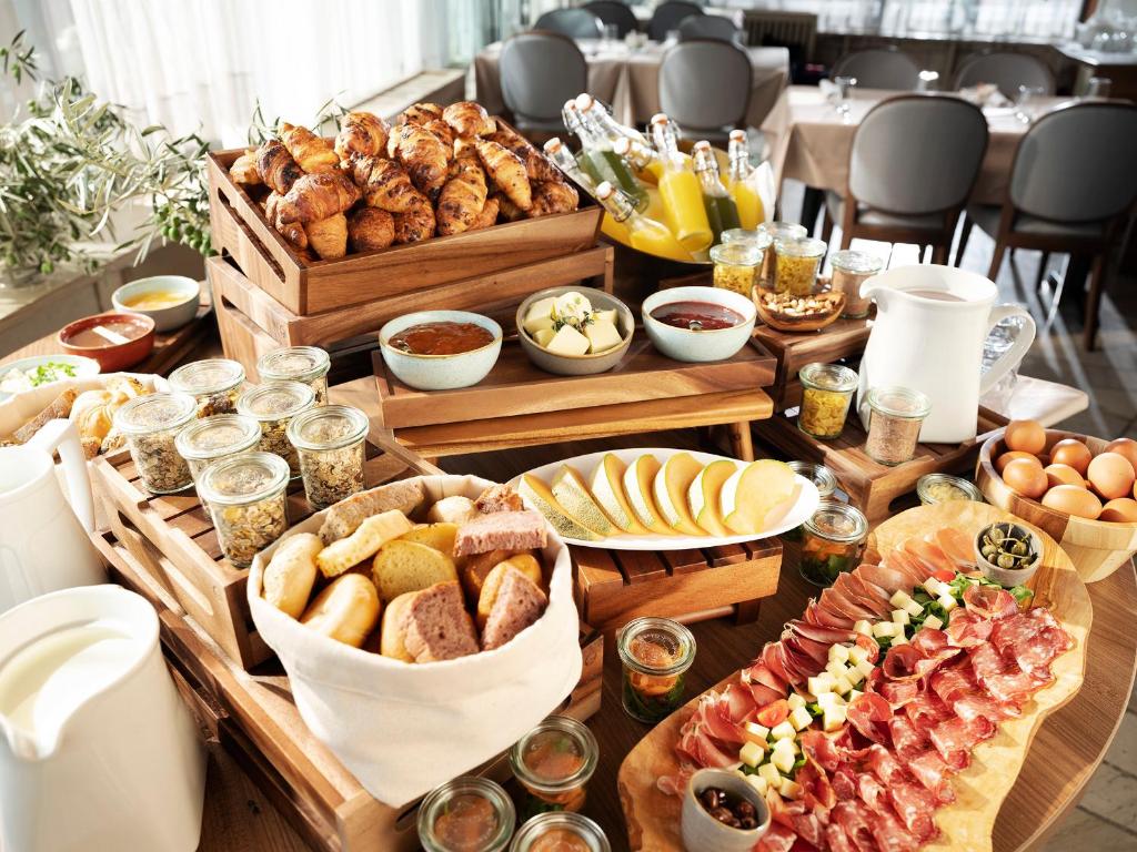 a table filled with lots of different types of food at Hotel Cliff Belvedere in Izola