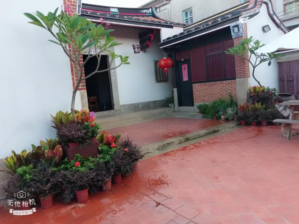 a courtyard of a house with flowers and a building at Sunny's Home in Jincheng