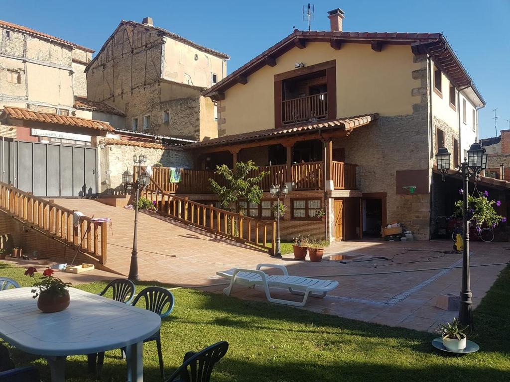 a house with a table and chairs in a yard at Algarabiastaying 1 Cristeta in Medina de Pomar