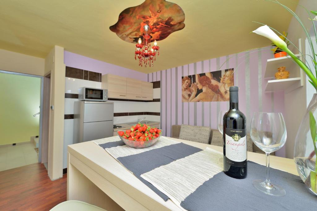 butelka wina na stole z kieliszkiem wina w obiekcie Apartments Carpe Diem w mieście Novigrad