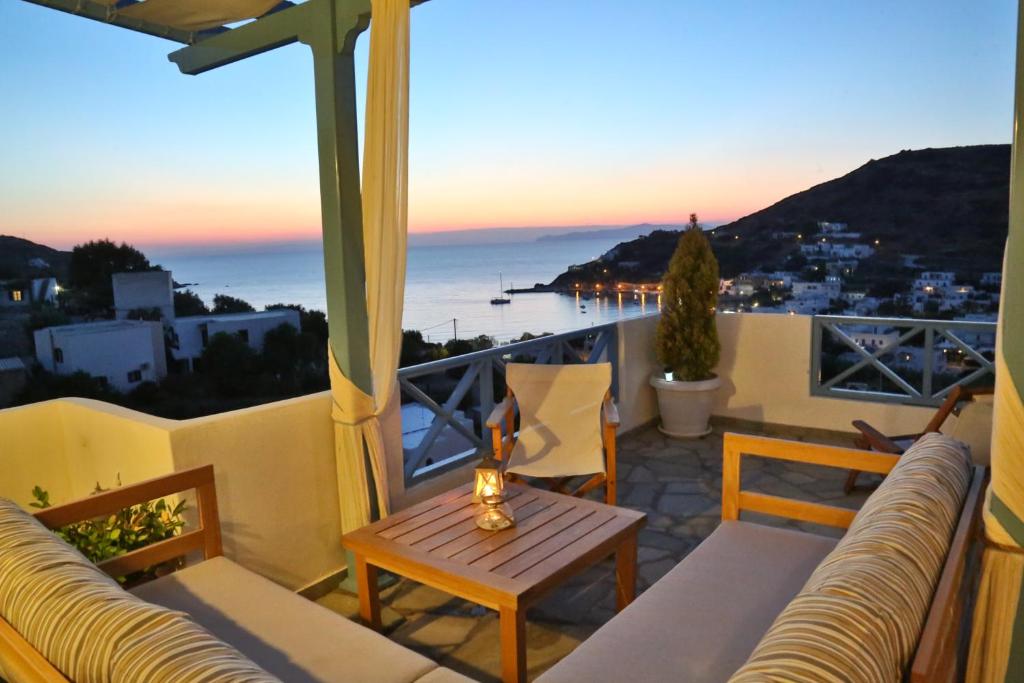 a balcony with a table and a view of the ocean at Kini Bay in Kini