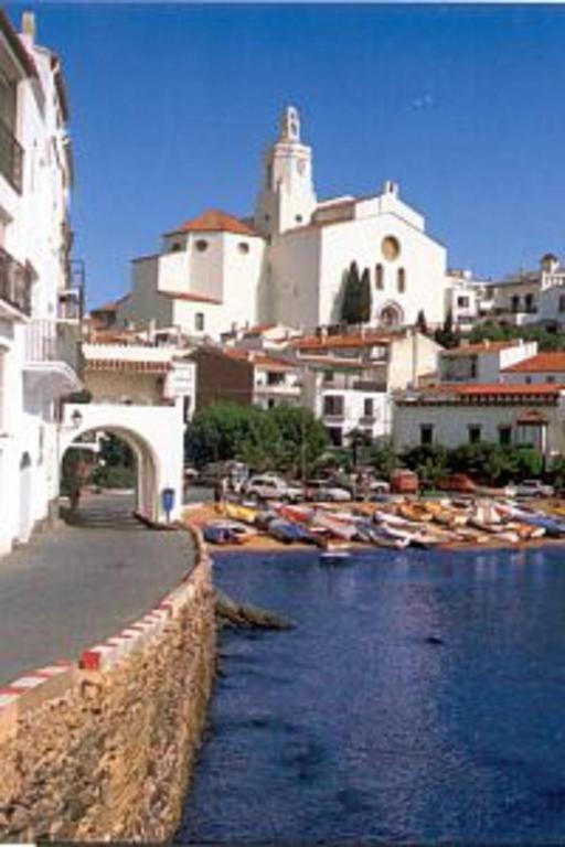 a group of boats in a body of water with buildings at Casas del Mar in Cadaqués