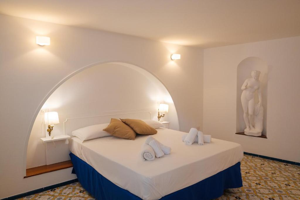a bedroom with a bed with two towels on it at Dolce Pausa in Atrani