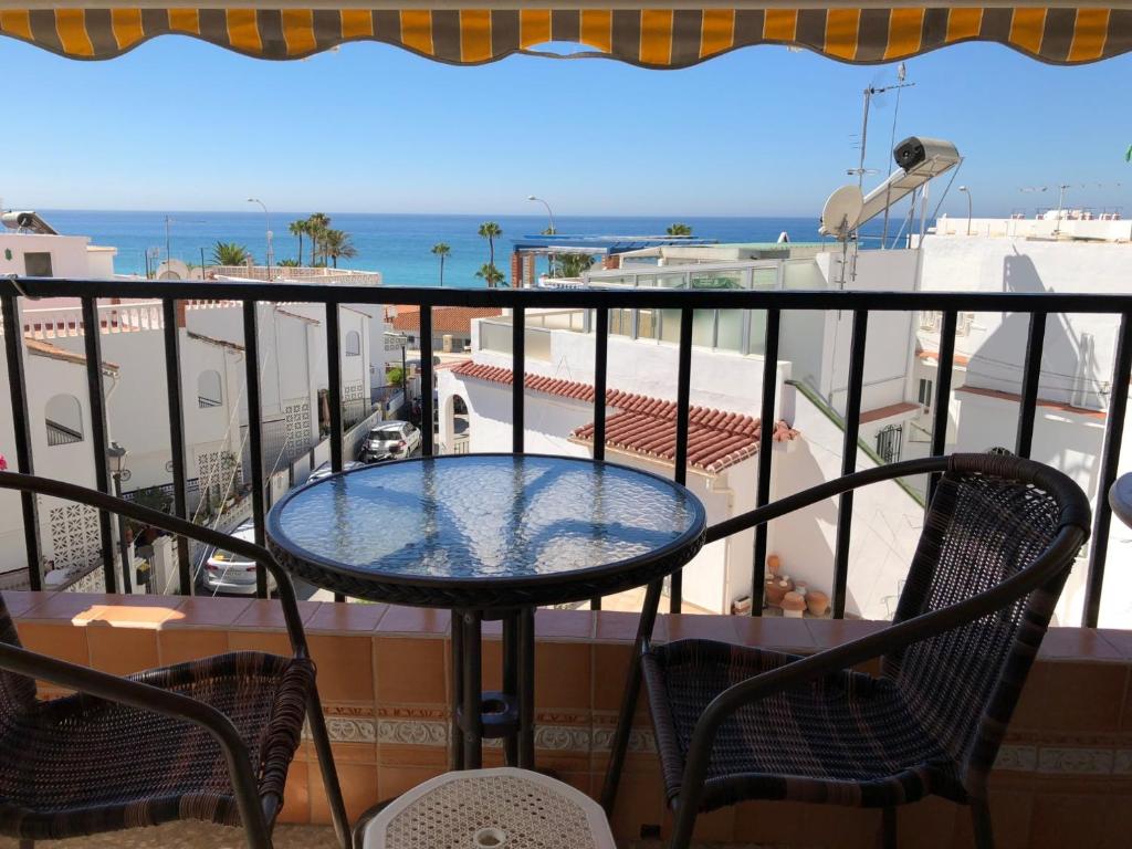een tafel op een balkon met uitzicht op de oceaan bij ALBAIDA II 2B MENYBER in Nerja
