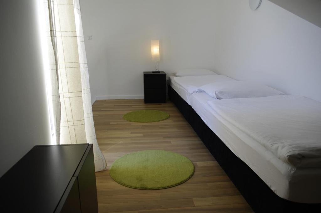 Postel nebo postele na pokoji v ubytování Apartments Santis10