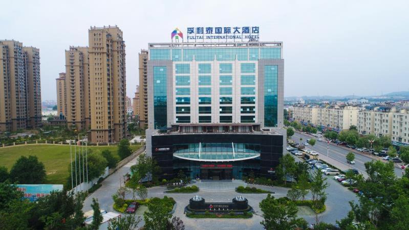 a large building with a pool in front of it at Fulitai International Hotel in Yantai