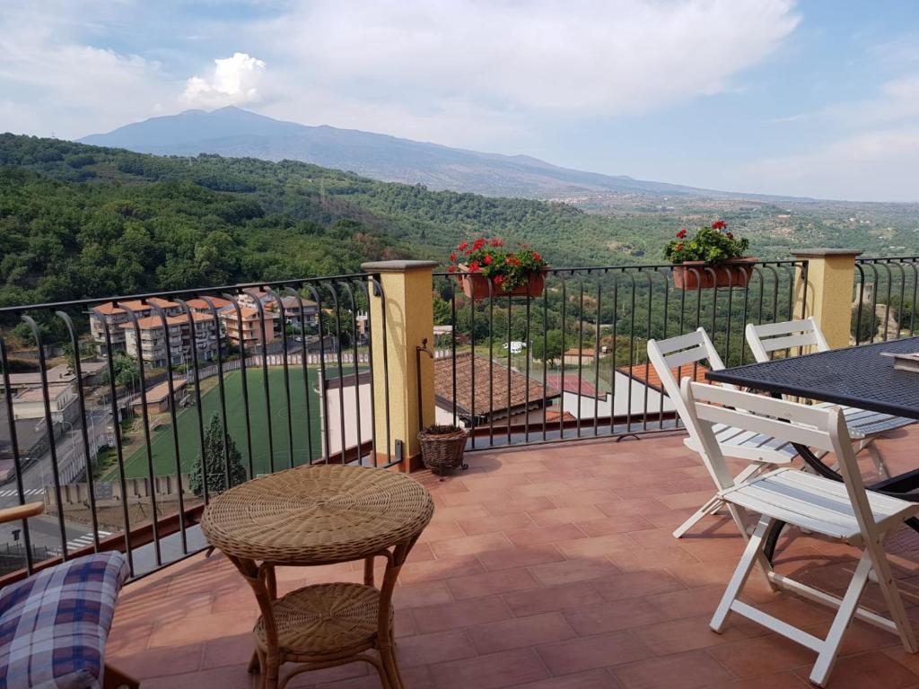 a balcony with a table and chairs and a view at Casa Francesca in Castiglione di Sicilia