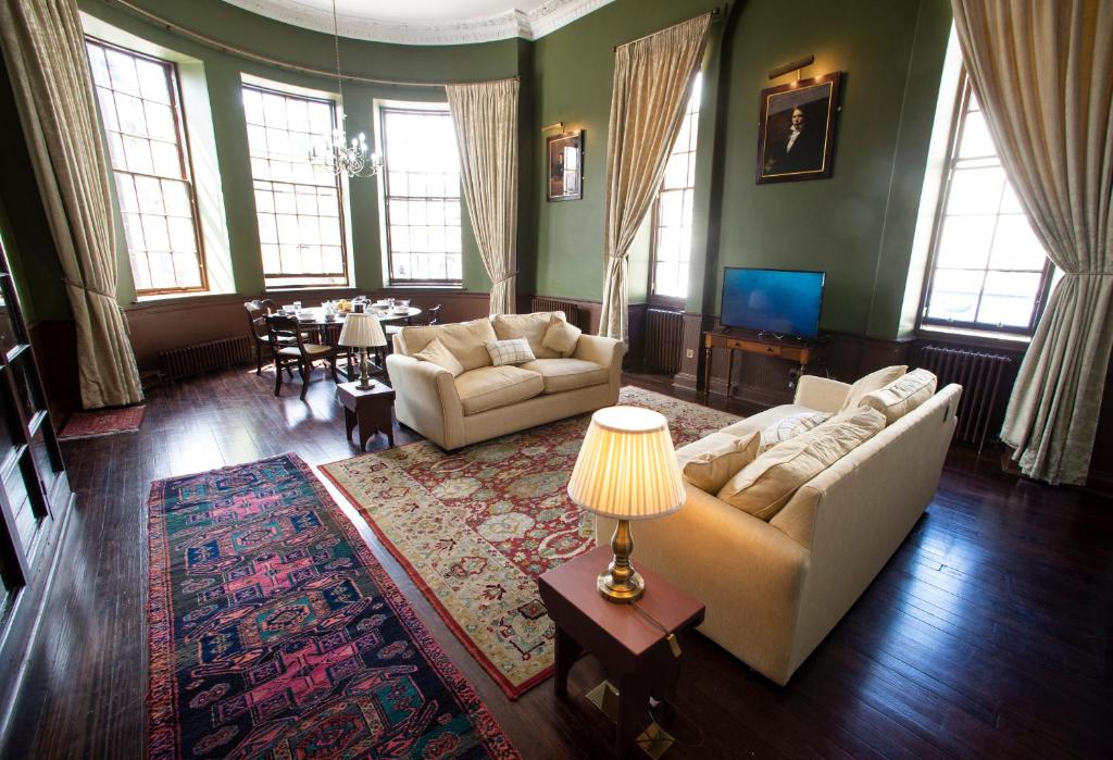 a living room with two couches and a table at Cupar Burgh Chambers in Cupar