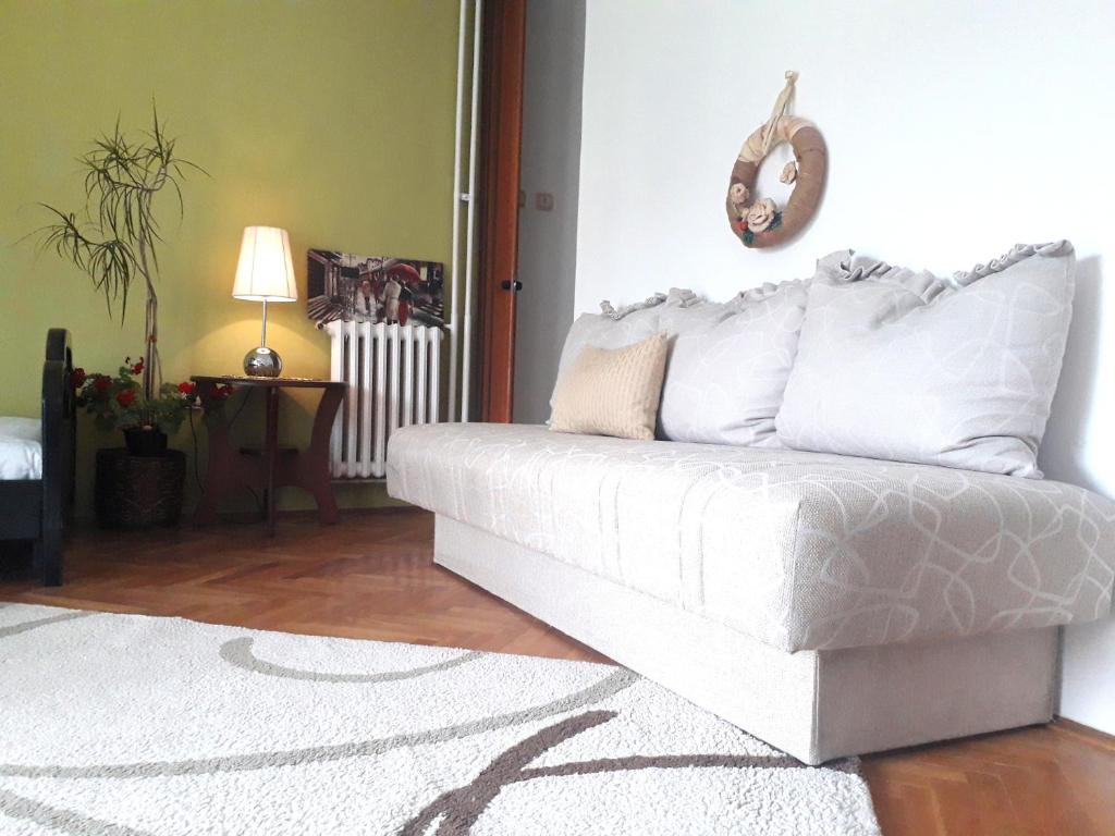 a white couch sitting in a living room at Principessa Apartment in Belgrade