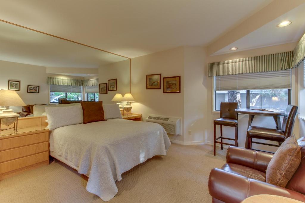a bedroom with a bed and a desk and a chair at Seclusion in Century West in Bend