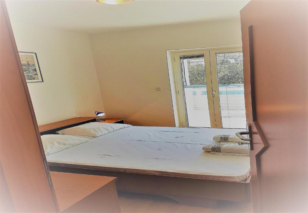 Postel nebo postele na pokoji v ubytování Apartments Vrtlici