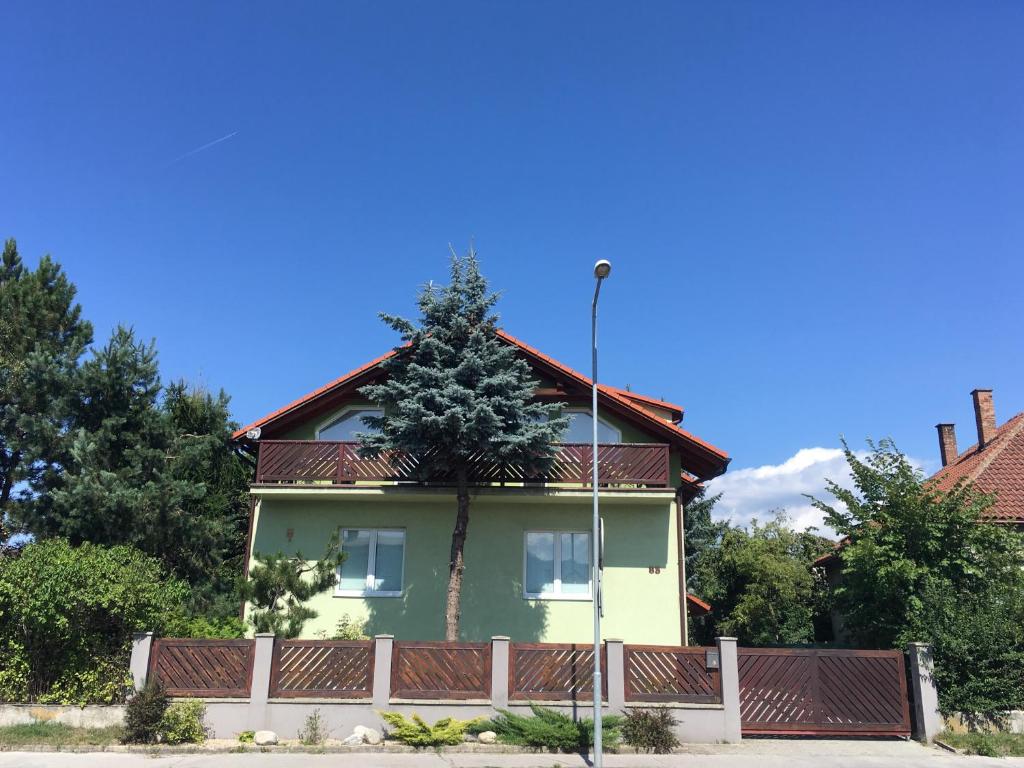 a house with a tree on top of it at Apartment Albi in Liptovský Mikuláš
