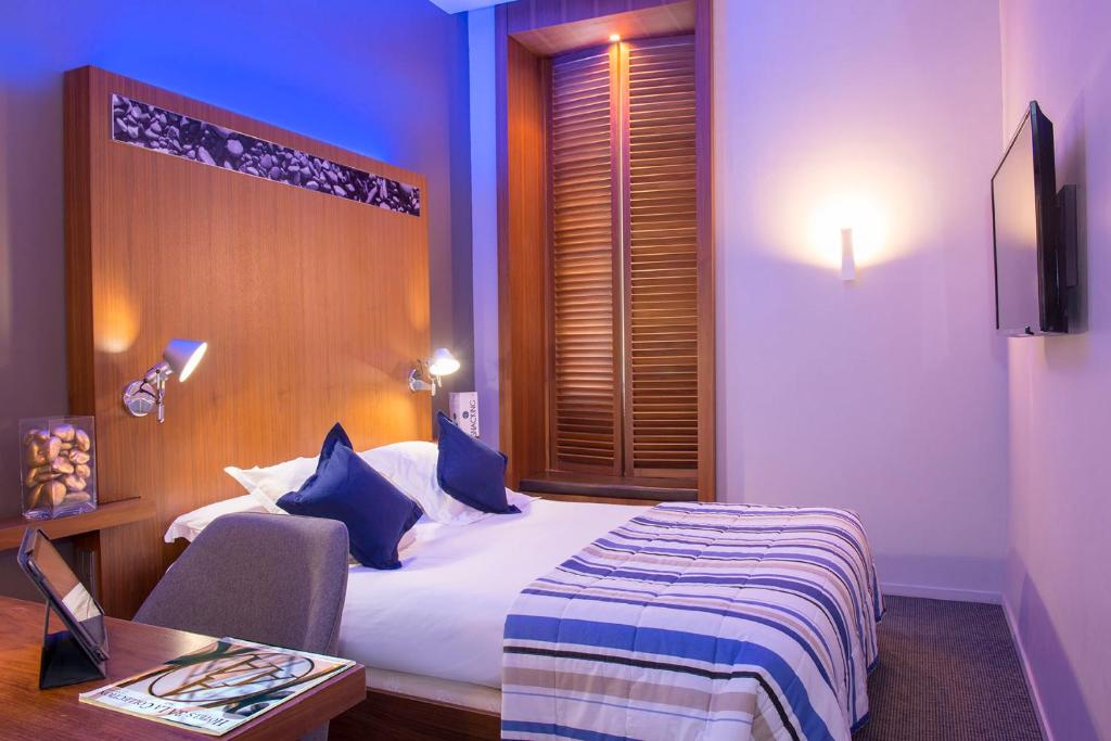 Cama ou camas em um quarto em Hotel Beau Rivage