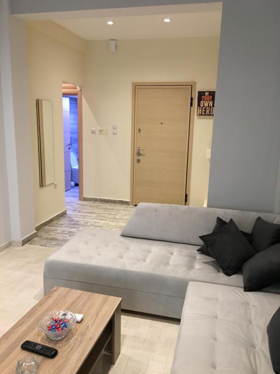 a living room with a couch and a coffee table at Acropolis brand new 1min from metro! in Athens