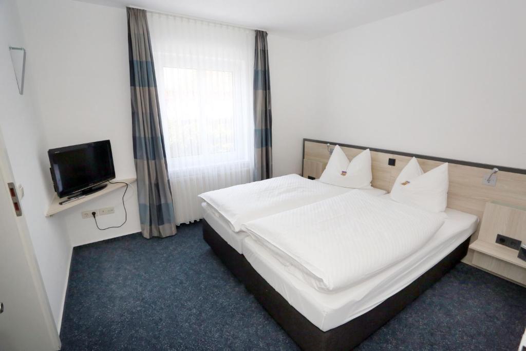 Postel nebo postele na pokoji v ubytování Hotel 7 Säulen GmbH