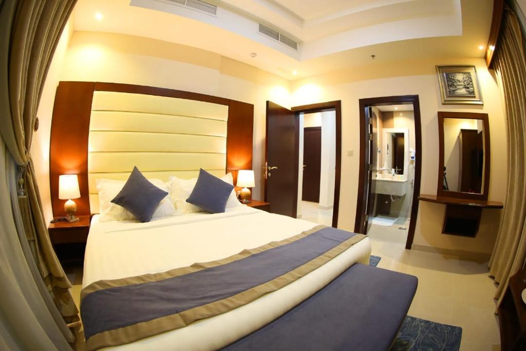 Postel nebo postele na pokoji v ubytování SAS Al Olaya Hotel Suites