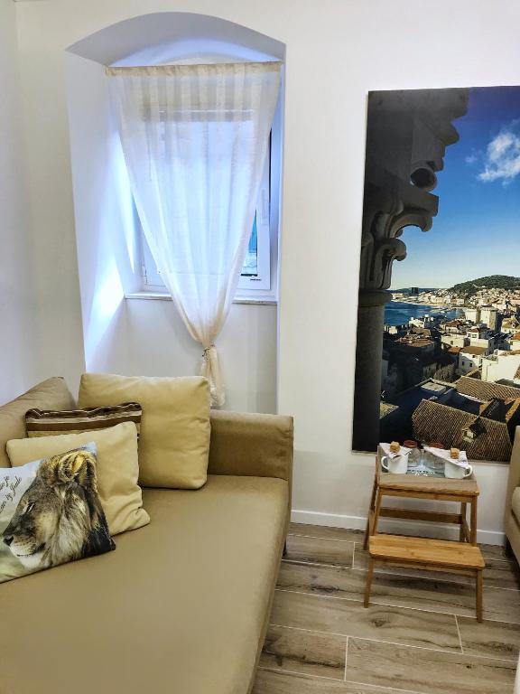 a living room with a couch and a window at Old town hesed in Split