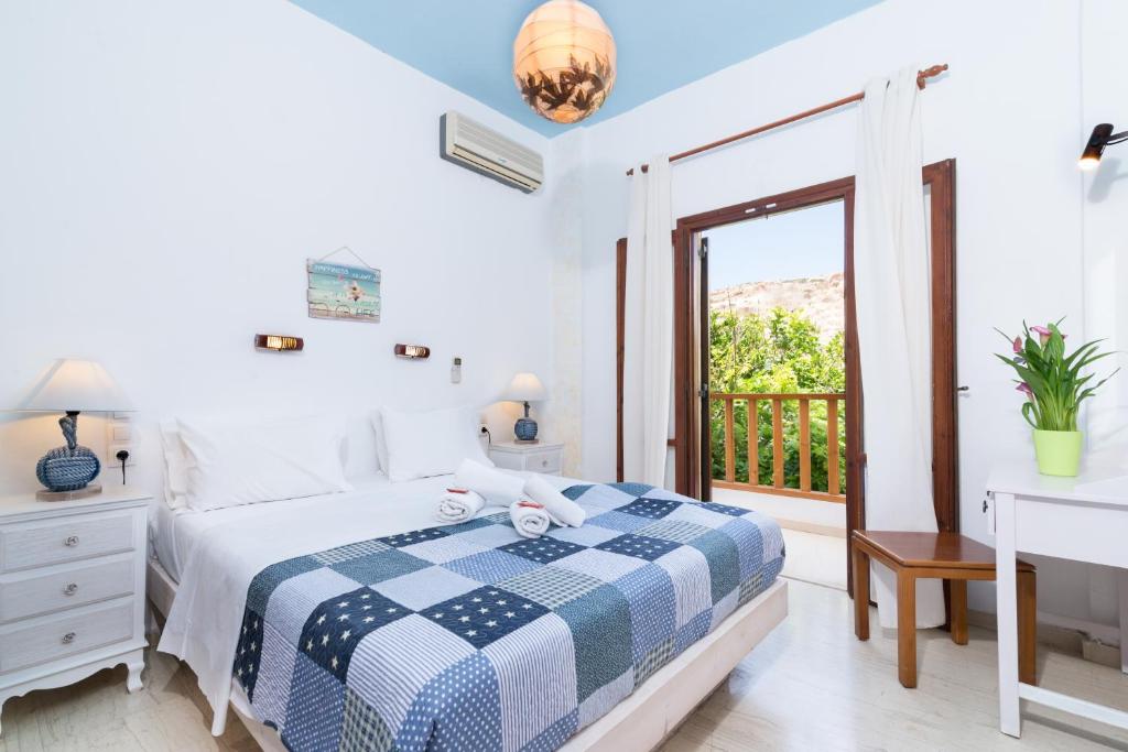 a bedroom with a bed and a balcony at Hotel Sofia in Matala