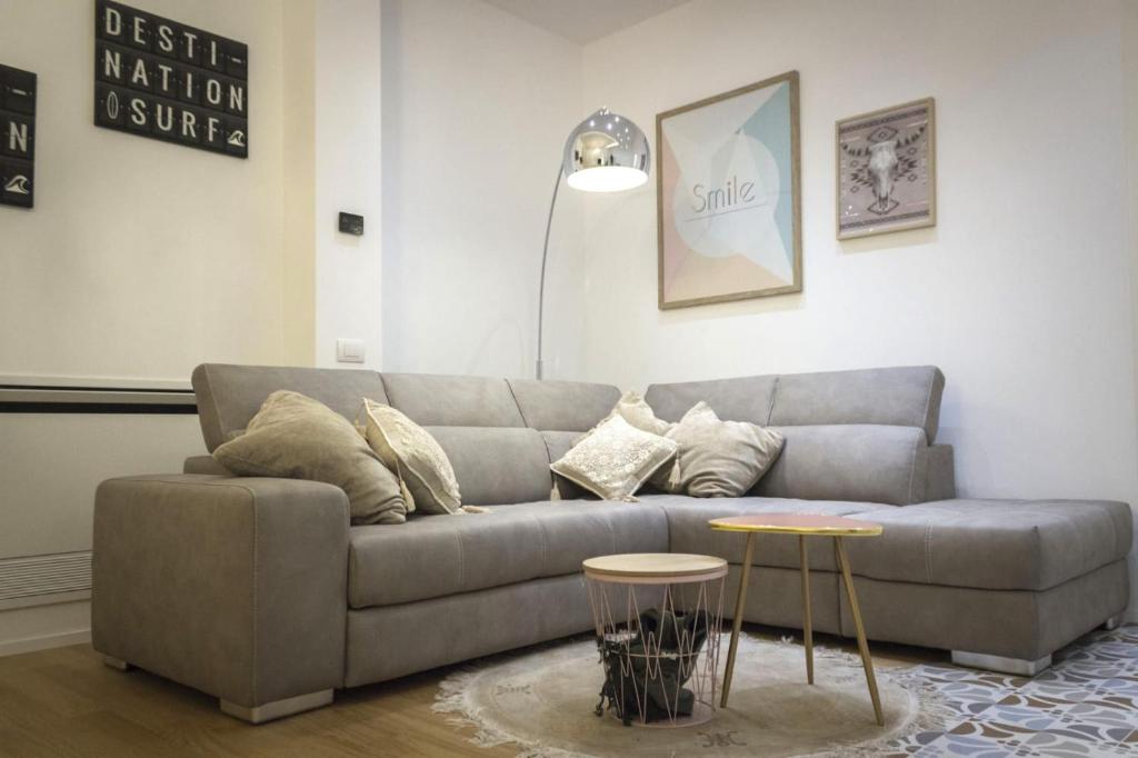 a living room with a couch and two tables at L'ULIVO - home suite in Bari