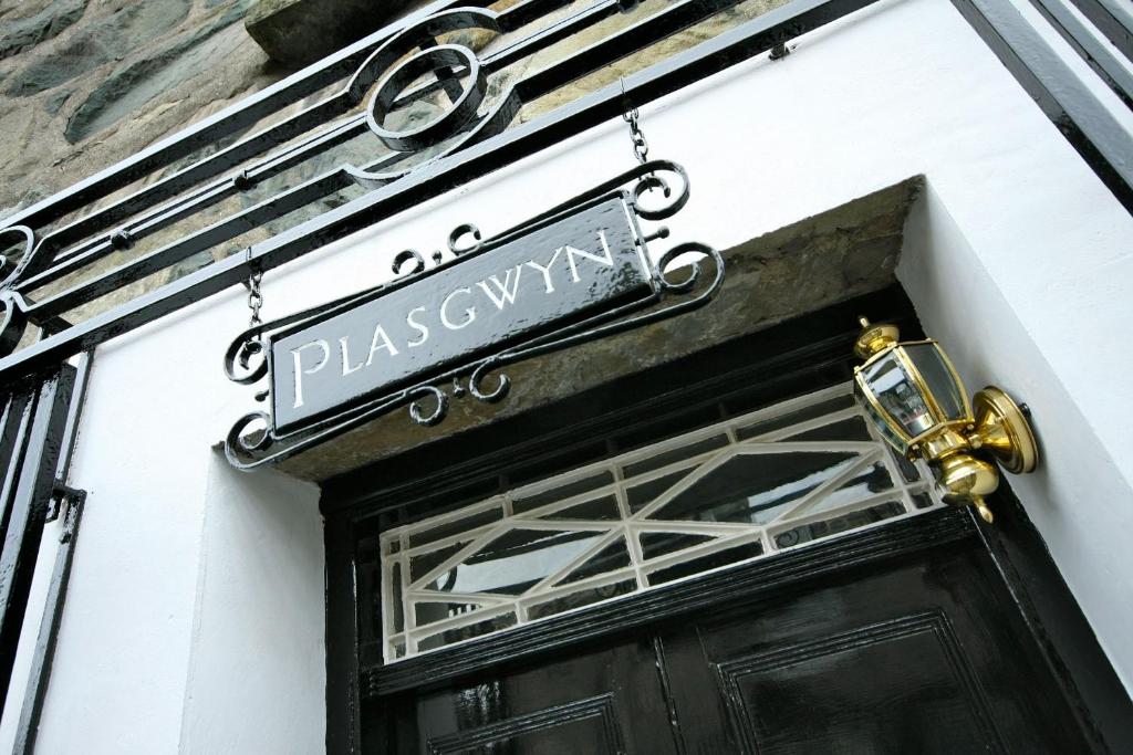 a black door with a sign for a pharmacy at Plas Gwyn B&B and Holiday Cottage in Dolgellau