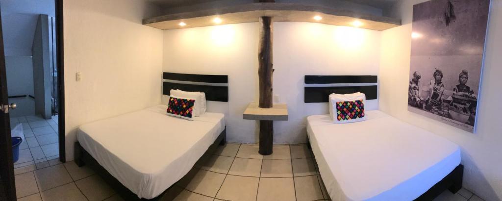 Postel nebo postele na pokoji v ubytování Hotel Maya Rue