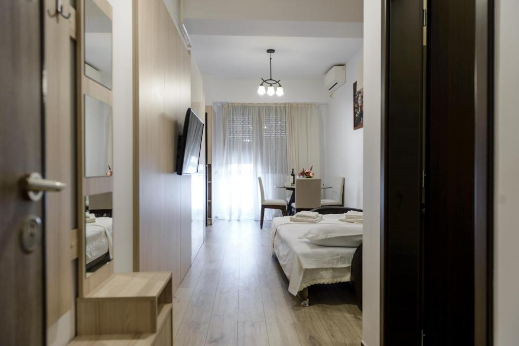 a hotel room with a bed and a desk at Studios & Apartments Palas by GLAM APARTMENTS in Iaşi