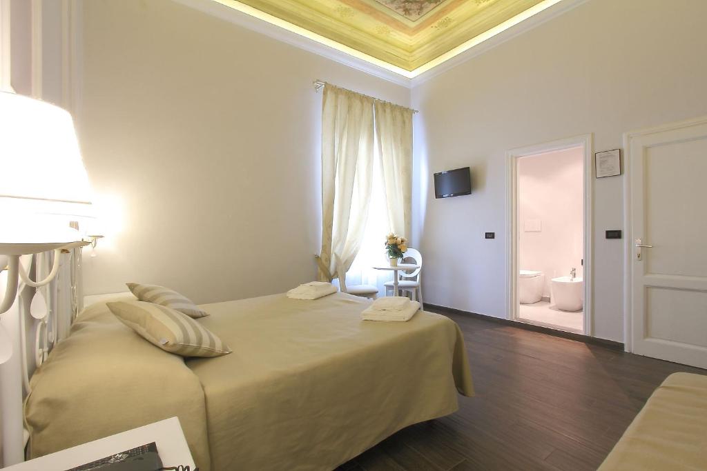 Postel nebo postele na pokoji v ubytování Hotel Ferrucci