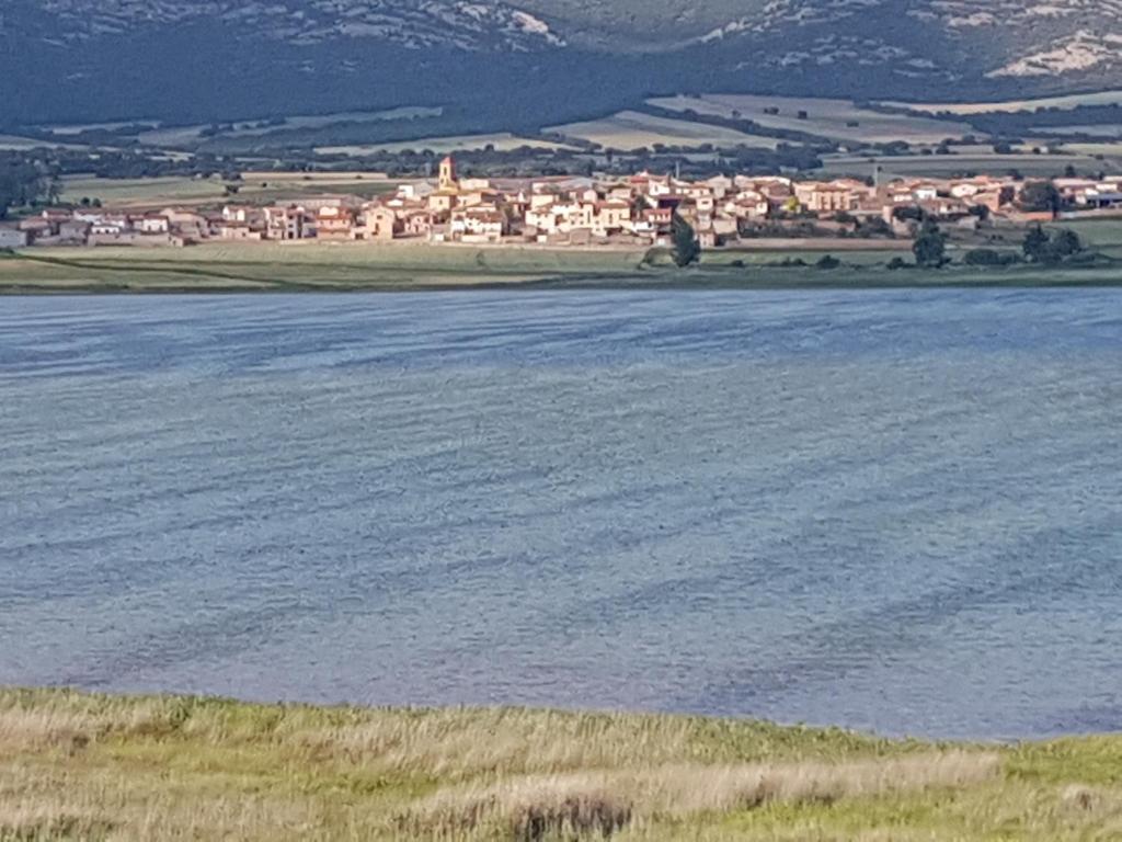 a large body of water with a town in the background at Casas rurales LA LAGUNA y LA BUHARDILLA DE LA LAGUNA in Gallocanta