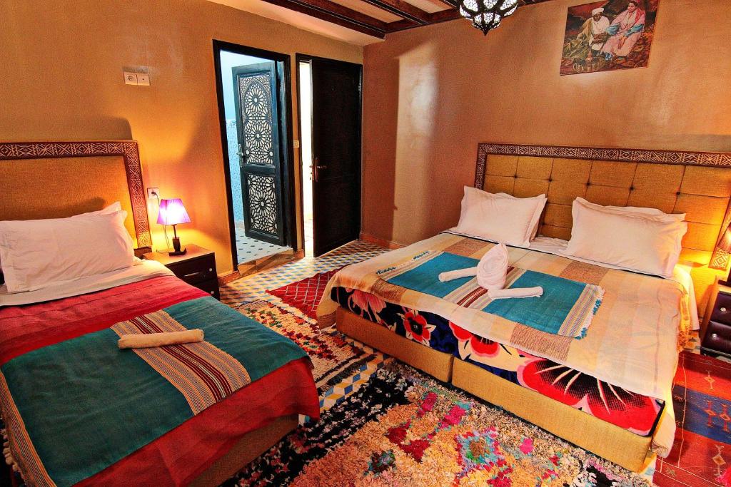 a bedroom with two beds and a window at Toubkal Garden in Imlil