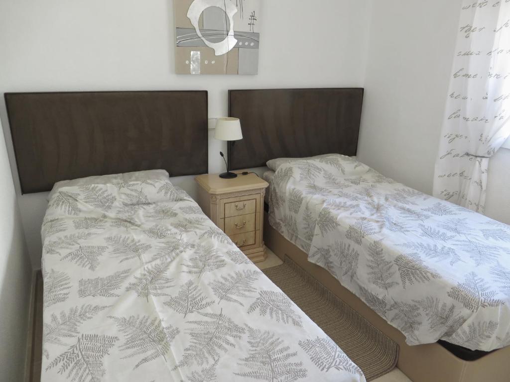 A bed or beds in a room at Superbe appartement avec piscine (Costa Blanca)