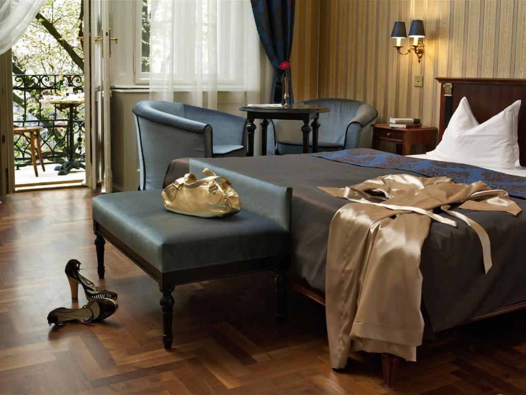 
a bed sitting in a room next to a window at Gerlóczy Boutique Hotel in Budapest
