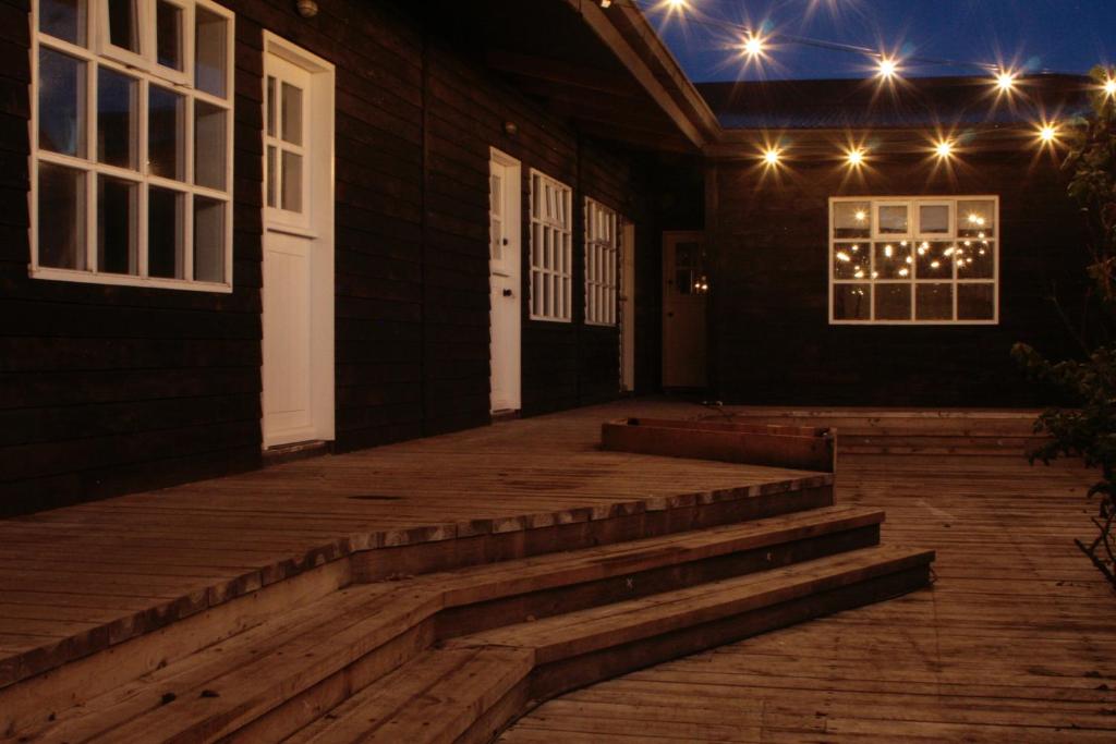 a porch of a house with stairs and lights at El Establo in Puerto Natales