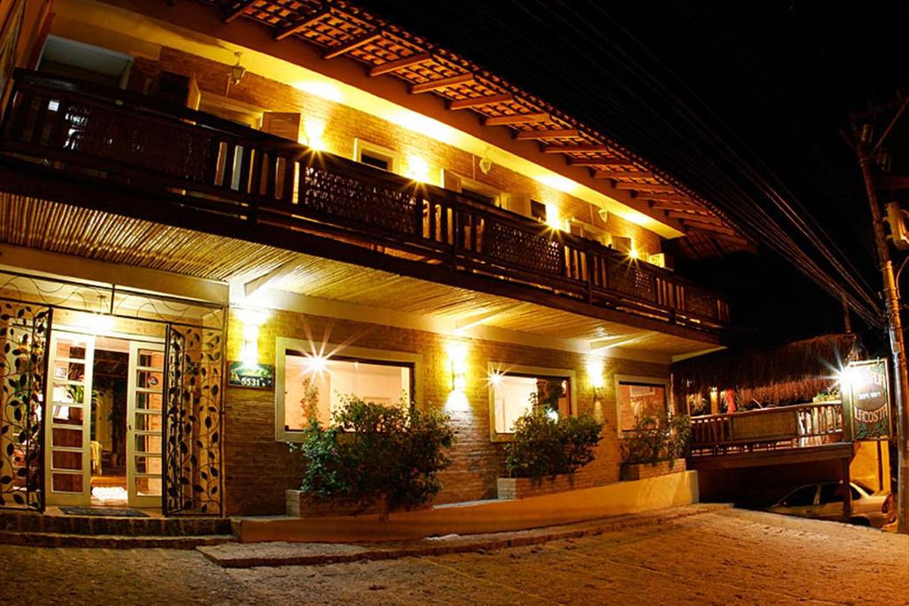a building with lights on the side of it at night at Pousada Lacosta in Ilhabela