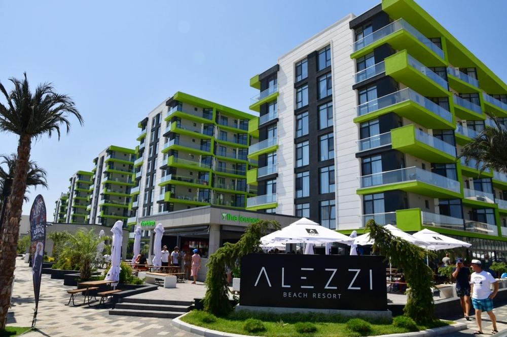 a large apartment building with a sign in front of it at Mamaia Nord - Apartament Beach Resort in Mamaia Sat/Năvodari
