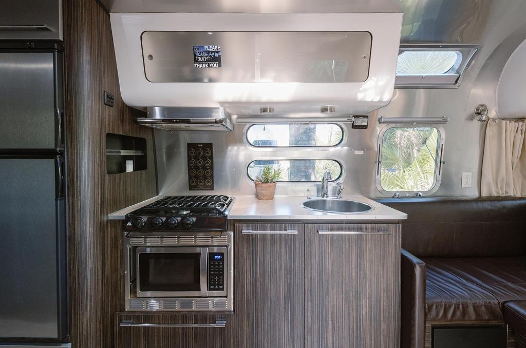 an rv kitchen with a sink and a stove at Caravan Outpost in Ojai