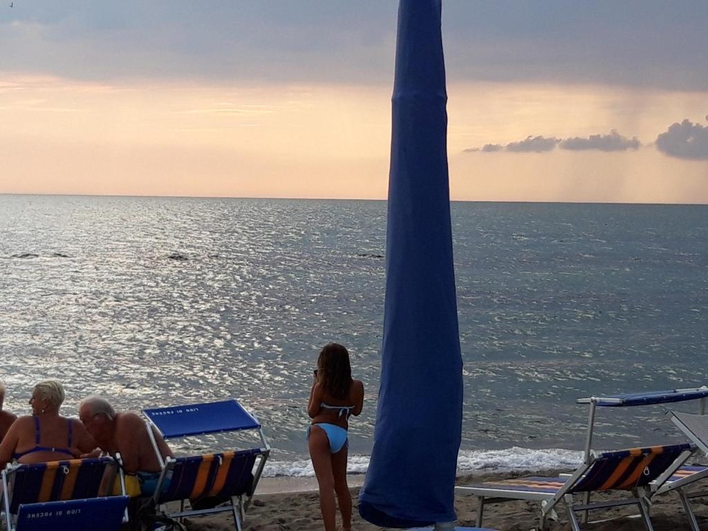 a group of people in bathing suits on a beach at Sabrina Airport in Fiumicino